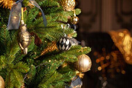 Close-up of a Christmas tree decorated with gold balls and blue bows. Christmas holiday concept. Free space for textの写真素材