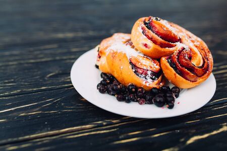 Rustic with black current berry filling pie on black wooden table background. Tasty breakfast. Bakery Fresh Healthy breakfast. Unhealthy food with glutenの写真素材