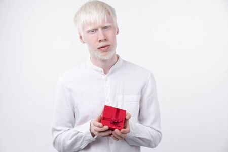 portrait of an albino man in  studio dressed t-shirt isolated on a white background. abnormal deviations. unusual appearance. skin abnormalityの写真素材
