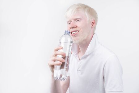 portrait of an albino man in  studio dressed t-shirt isolated on a white background. abnormal deviations. unusual appearance. skin abnormalityの写真素材