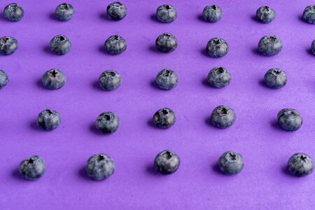 Colorful fruit pattern of blueberries on purple background. Top view. Flat lay の写真素材