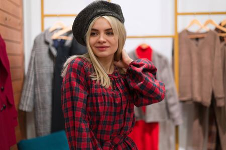 One caucasian women in a fashion boutique choose dress.  A professional stylist helps customers choose clothes. Season holiday shopping discounts sale European girl walk shopping mall. Lifestyle の写真素材