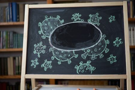 Outbreak Warning. written white chalk on blackboard in connection with epidemic of coronavirus...