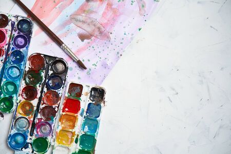 Set of watercolor paints white background. Brushes drawing. Creative background. School for teaching drawing. With copy space for textの写真素材