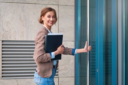 Business woman open door