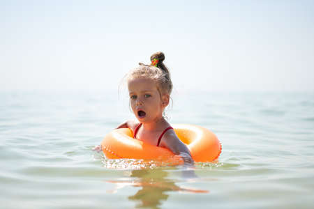 Child swims sea inflatable ring. danger of drowning Safety equipment, Child Life buoy Little...
