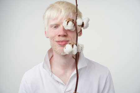 albinism Happy smile albino man white skin hair soft fluffy cotton brunch studio dressed t-shirt isolated white background abnormal deviations unusual appearance abnormality Beautiful peopleの写真素材