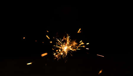 Sparkler background. Christmas and new year sparkler holiday background. bengal light on the black backgroundの写真素材