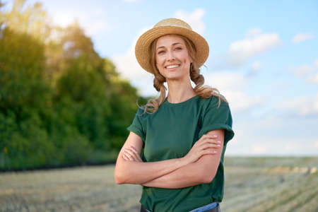 Woman farmer straw hat standing farmland smiling Female agronomist specialist farming agribusiness...