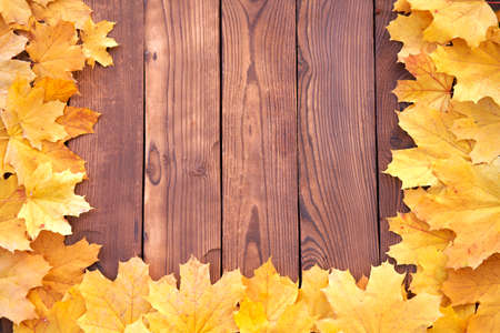 Autumn leaves frame on wooden background top view Fall Border yellow and Orange Leaves vintage wood...