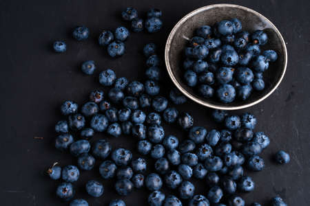 Blueberry antioxidant organic superfood in ceramic bowl concept for healthy eating and dieting nutrition Top view on dark black backgroundの写真素材
