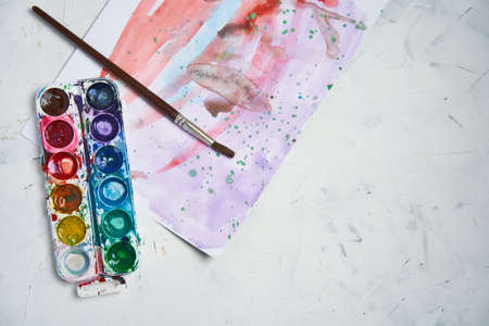 Set of watercolor paints white background. Brushes drawing. Creative background. School for teaching drawing. With copy space for textの写真素材