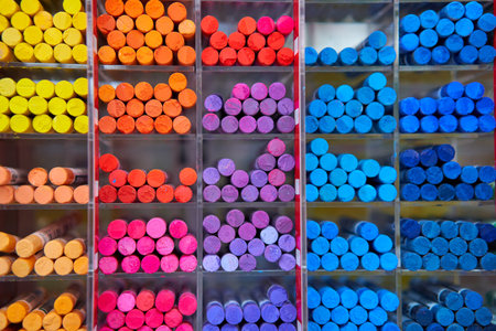 Multicolored pastel crayons art store in wooden cells. Artspace, workshop, creativity concept....