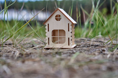 Miniature wooden house outdoor nature. Real estate concept. Modern housing. Eco-friendly energy...