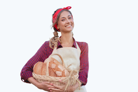 Woman dressed apron white background Farmer bread basket Agricultural concept Caucasian middle age Female business owner in uniform Happy one person smiling Time to advertise Banner Thumb upの写真素材