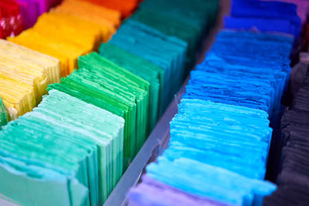Sheets colored cardboard for designer creative works. Stacks multicolored drawing paper in the...