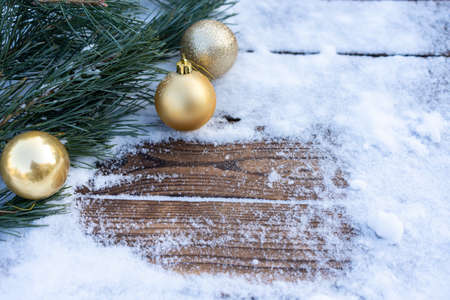 Winter background. Empty wooden plank with snowy border with pine branch and christmas ball decoration, copy space for text Wood table to. For product display Christmas time mock upの写真素材