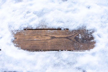Winter background. Empty wooden plank with snowy border, copy space for text Wood table to. For product display Christmas time mock upの写真素材