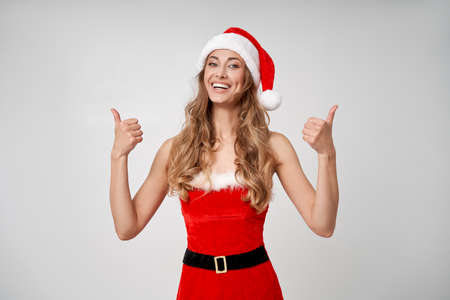 Woman christmas Santa Hat white studio background Beautiful caucasian female curly hair portrait...