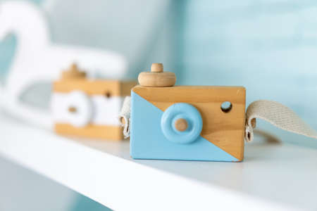 Toy wooden camera for children or decoration standing on shelf Creative childhood conceptの写真素材