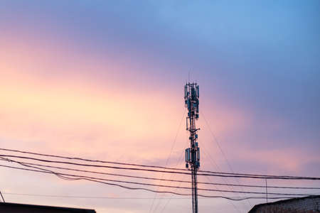 Cell Tower Silhouette Against Orange Sunset Communication Tower Technology Concept Handheld Transmitter Equipment Fort Television Cell Phones Internet Signalの写真素材