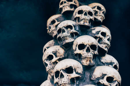 Skull Halloween Background Many People Skulls Stand on top of each other. Mystic creepy concept. Abstract nightmare occult memorial.の写真素材