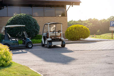 Golf car standing parking golf club Warm summer day Luxury lifestyle conceptの写真素材