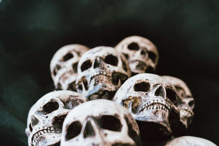 Skull Halloween Background Many People Skulls Stand on top of each other. Mystic creepy concept. Abstract nightmare occult memorial.の写真素材