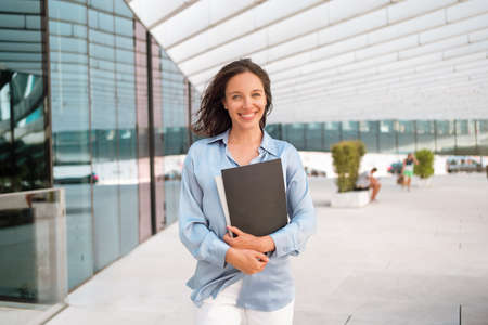 Businesswoman successful woman business person walking outdoor corporate building exterior Excited...