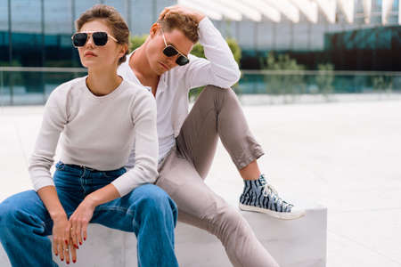 Young couple having problems in their relationship. man and woman friends in sunglasses sitting...
