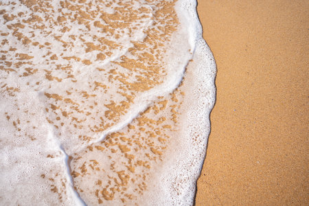 Soft beautiful ocean wave on sandy beach. background. Turquoise color sea view with copy space