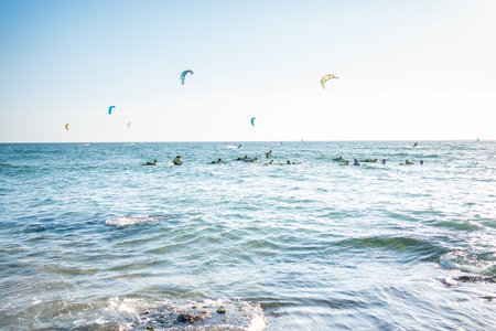 Group of surfboard students training to ride waves in Atlantic ocean. Surf lessons in the sea.の写真素材