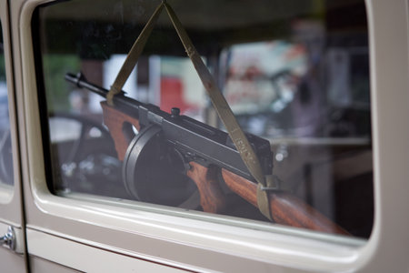 Closeup of RPD machine gun hanging inside car window. Powerful firearm against the backdrop of the...