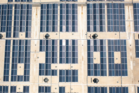 Solar panels installed on rooftop, harnessing renewable energy to power buildings with sustainable...