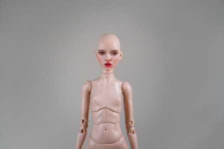 Doll with detachable head and detailed facial features. The doll body is shown with neutral expression against gray background, highlighting craftsmanshipの写真素材