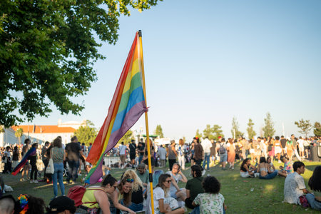Lisbon, Portugal 17 June 2023 Crowds gather in a park for a colorful gay parade, showcasing rainbow flags and festive attire.のeditorial素材