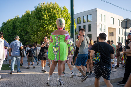 Lisbon, Portugal 17 June 2023 Participants enjoy a vibrant LGBT gay parade, showcasing colorful outfits and lively energy while walking through a bustling city street filled with supportersのeditorial素材
