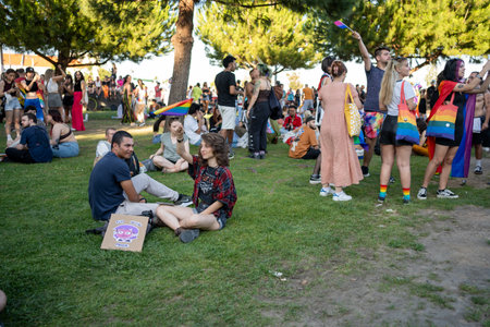 Lisbon, Portugal 17 June 2023 Crowds gather in a lively park to celebrate at the LGBT gay parade, with colorful flags and a joyful atmosphereのeditorial素材