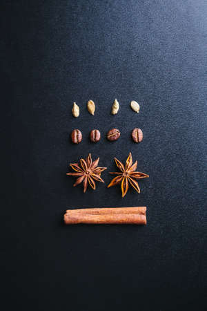Coffee, cardamom, star anise and cinnamon stick on dark background. Christmas moodの写真素材