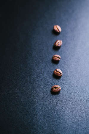 Grains of coffee on a dark background in a minimalistic style
