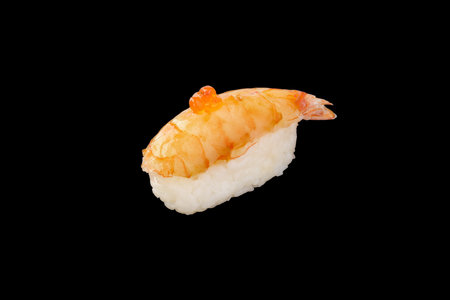 Nigiri sushi tiger shrimp, red caviar isolated on black backgroundの写真素材