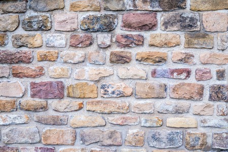 Ancient Colorful Wall with Bricks of Different Sizes and Colorsの写真素材