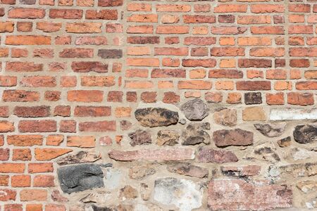 Ancient Colorful Brick Wall With Parts of the Wall Severly Worn Out