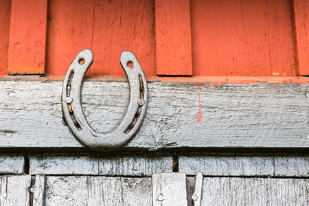 A Black Painted Horseshoe on Barn Wallの写真素材
