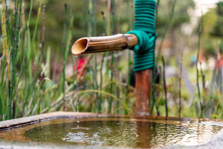 Close up of a japanese bamboo fountain into the Japanese Garden in Buenos Aires, Argentinaの写真素材