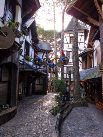 Decorative gnomes hanging in the middel of paved path holding starsの写真素材