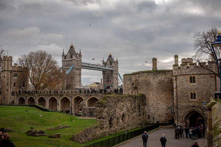 LONDON, ENGLAND, DECEMBER 10th, 2018: Tower Bridge in the UK. Seen from inside Tower of London in a cloudy winter day.のeditorial素材
