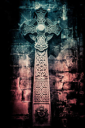 Wonderful embossed Celtic stone cross, full of details and textures in its elaborate carvingsの写真素材