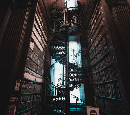 DUBLIN, IRELAND, DECEMBER 21, 2018: Magnificent spiral staircase in The Long Room in the Trinity College Library, home to The Book of Kells, full of details and ornamentedのeditorial素材