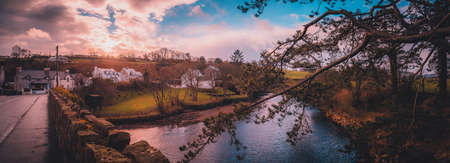 CUSHENDUN, NORTHERN IRELAND, DECEMBER 20, 2018: Beautiful panoramic view of Glendun River from over the bridge that cross it during sunset.のeditorial素材